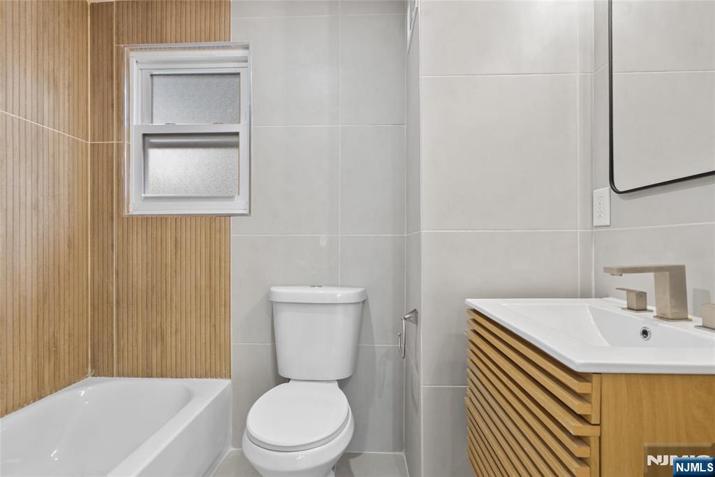 369 Hops Lane Secaucus, NJ 07094 - Photo 14 of 17 a bathroom with a sink a toilet and mirror