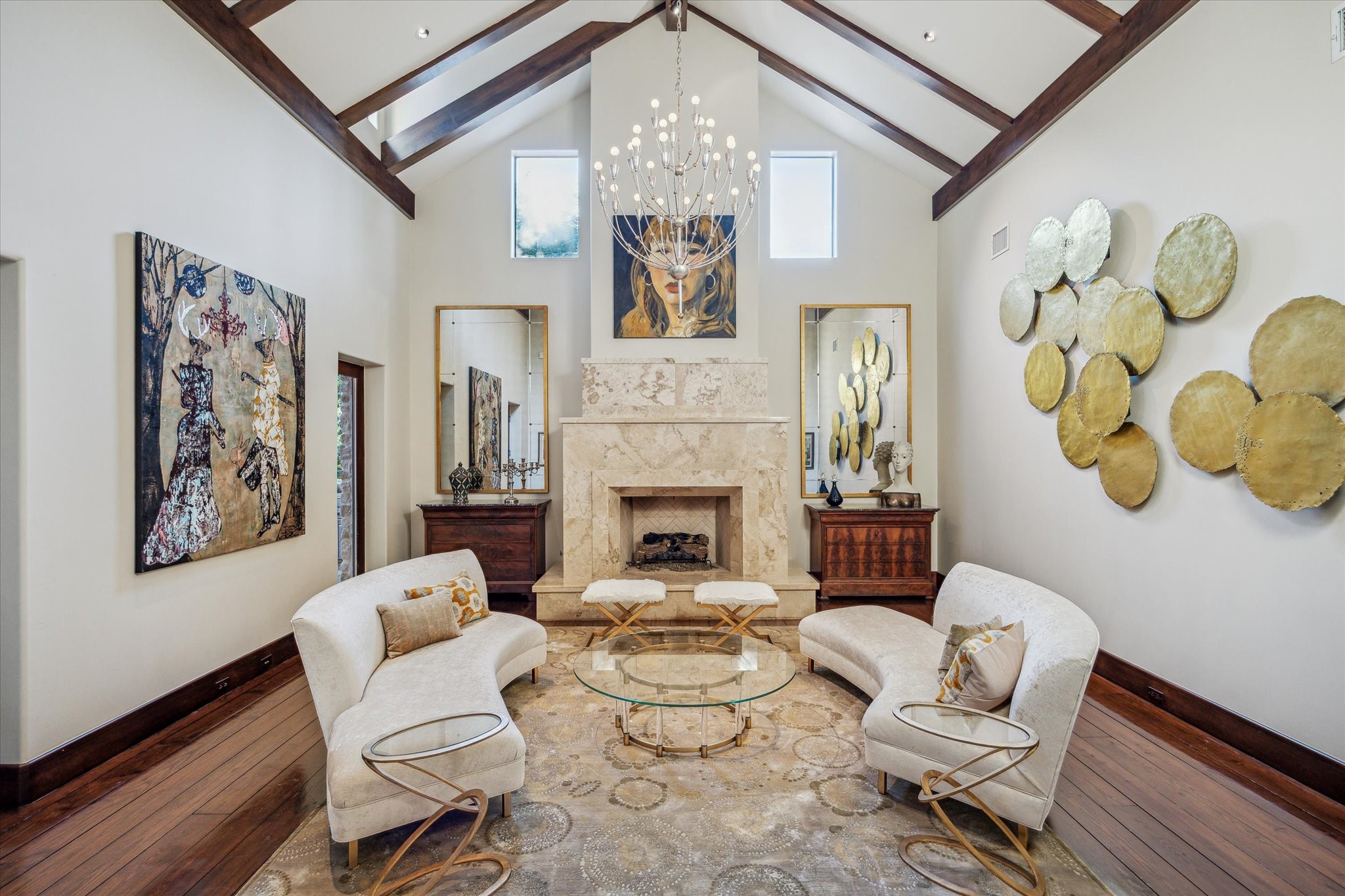 354 Piney Point Road Houston, TX 77024 - Photo 12 of 50 The formal sitting room boasts a gas fireplace with a marble accent, complemented by transom windows that fill the space with natural light and a vaulted ceiling that enhances the room's grandeur.
