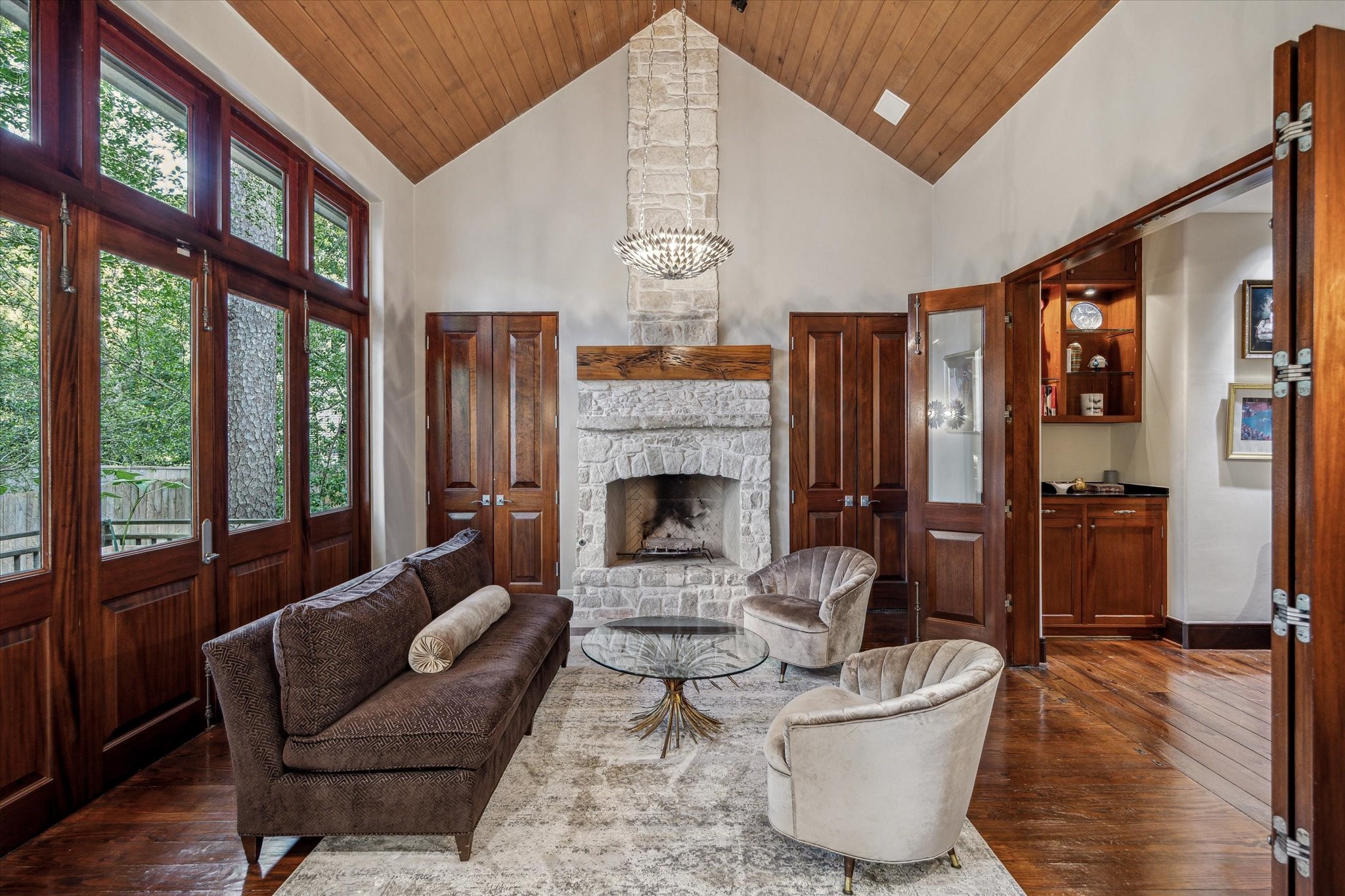 354 Piney Point Road Houston, TX 77024 - Photo 27 of 50 The primary suite features vaulted ceilings and a sitting area with a gas stone fireplace, accented by a wood-beamed ceiling and wooden French doors that open to a private Zen garden.