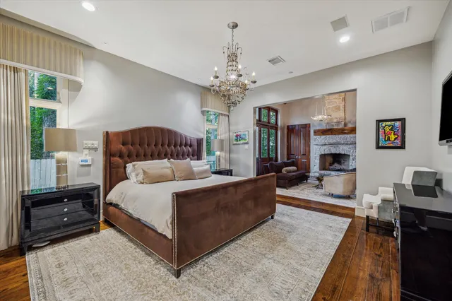 a spacious bedroom with a bed a couch and dresser