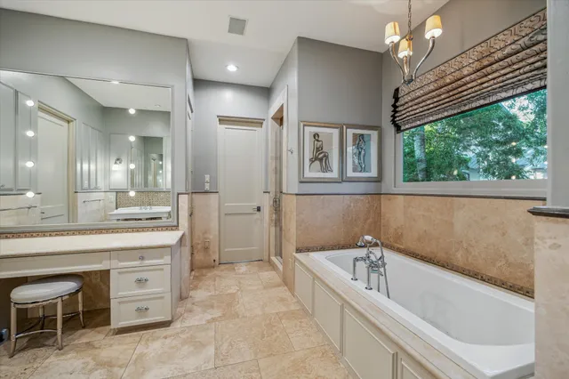 a spacious bathroom with a bathtub and a sink
