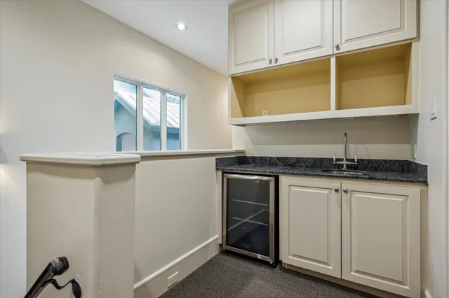 a kitchen with granite countertop cabinets stainless steel appliances and a sink