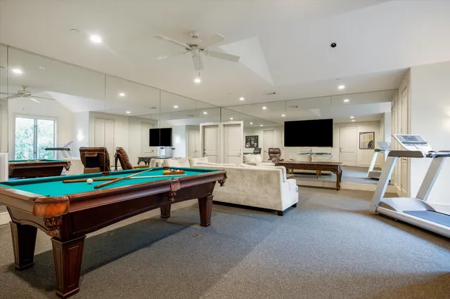 a room with furniture pool table and flat screen tv