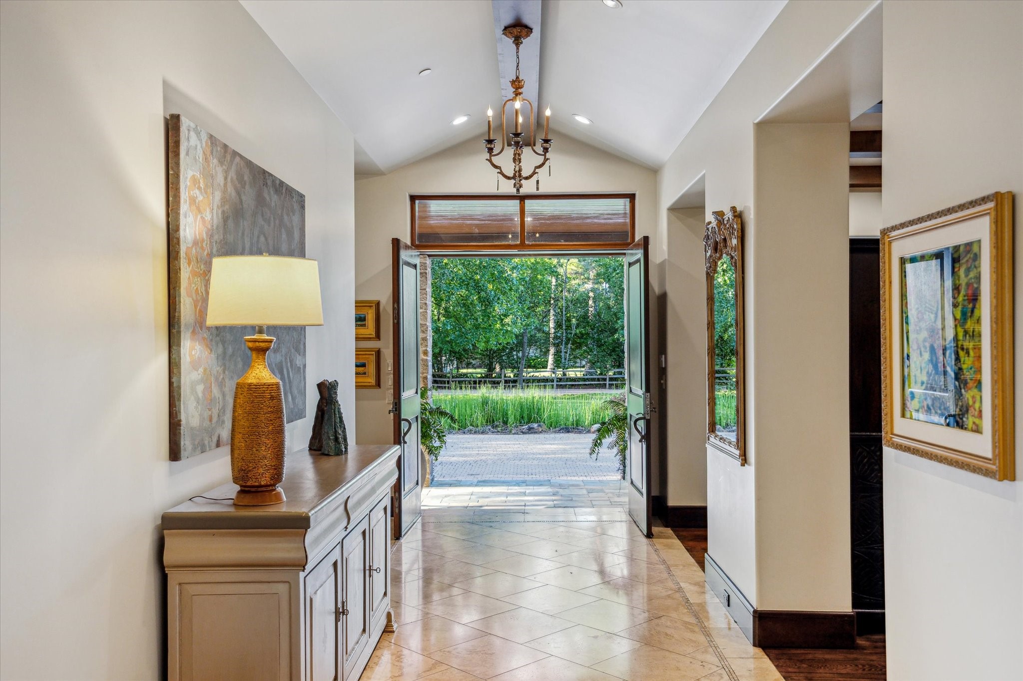 354 Piney Point Road Houston, TX 77024 - Photo 7 of 50 Located on a quiet cul-de-sac, this home boasts a beautiful front yard view and added privacy. Your double-door entry welcomes you into an elegant foyer, featuring vaulted ceilings accented with a striking wood beam.