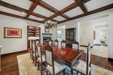 a dining room with furniture a rug and wooden floor