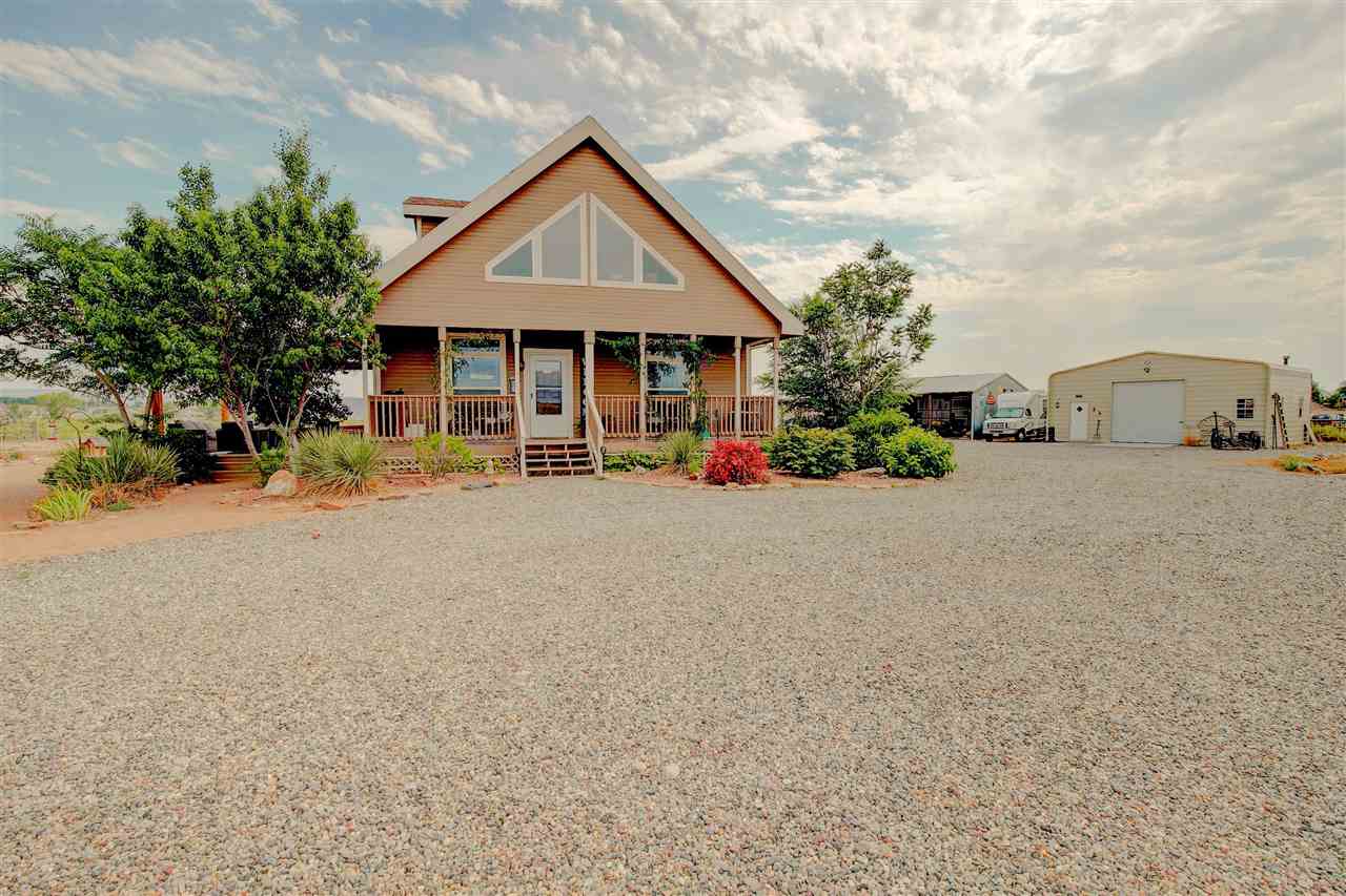 983 R Road Mack, CO 81525 - Photo 1 of 1 a front view of a house with a yard and garage