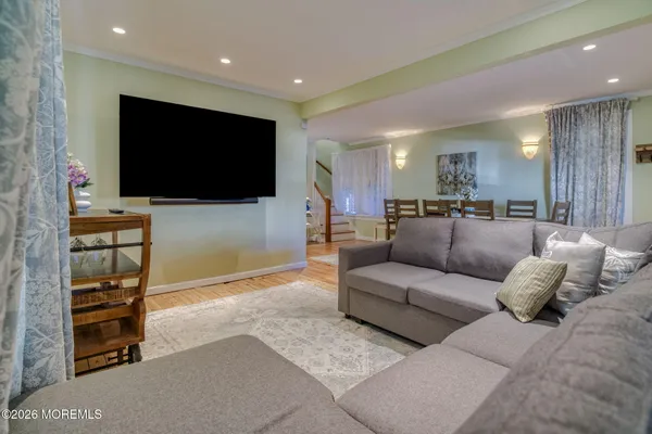 a view of a room with wooden floor and furniture