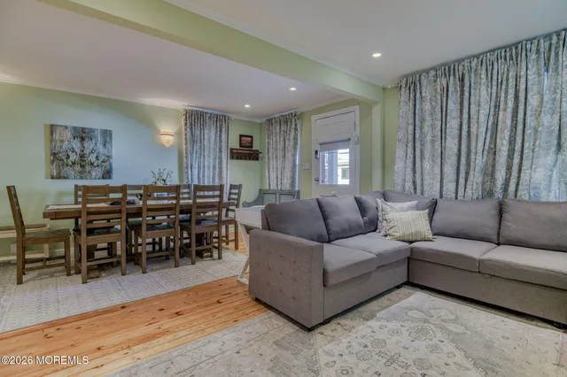 a dining room with furniture and wooden floor