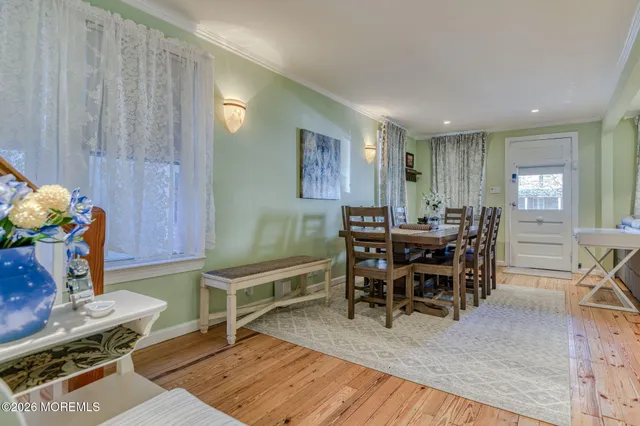 a view of a room with wooden floor and furniture