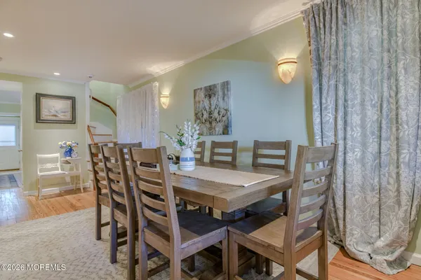 a dining room with furniture and wooden floor