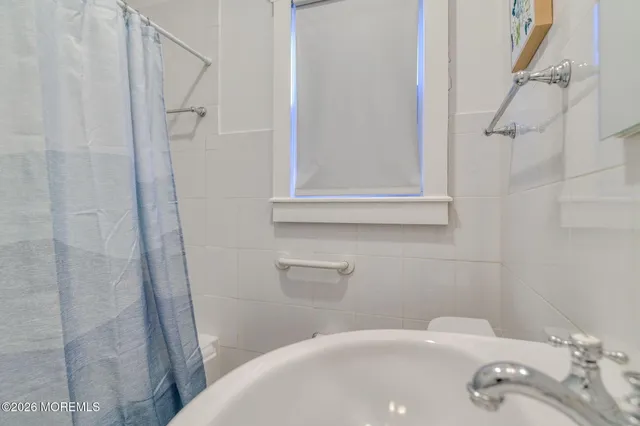 a bedroom with bed and window