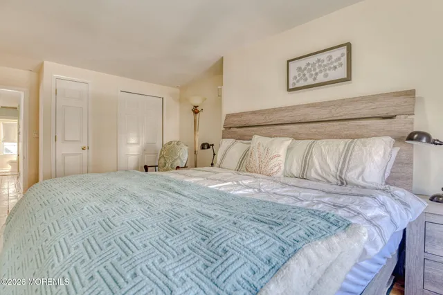 a bedroom with a bed and a chair