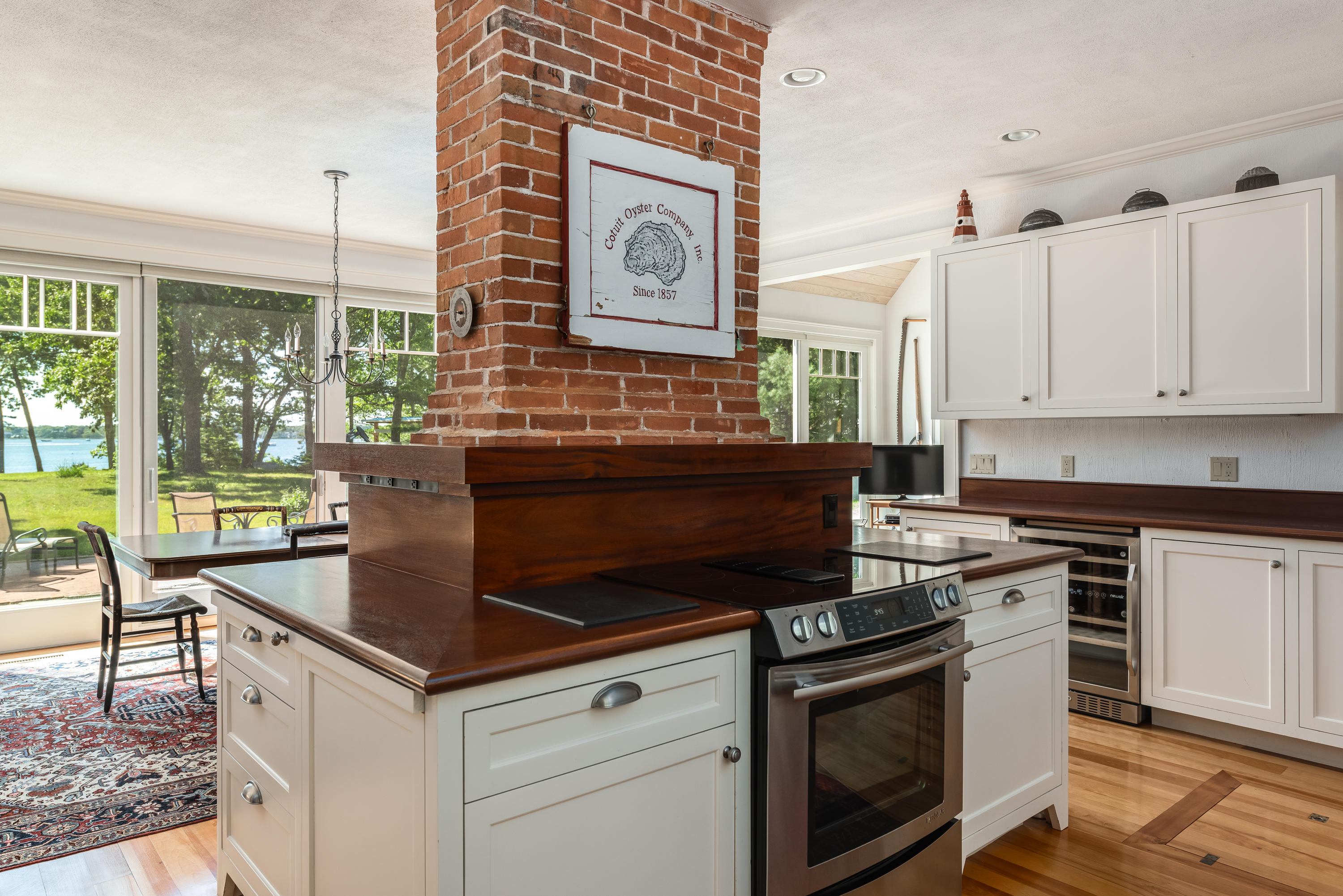 1075 Old Post Road Cotuit, MA 02635 - Photo 12 of 40 a kitchen with a stove and white cabinets