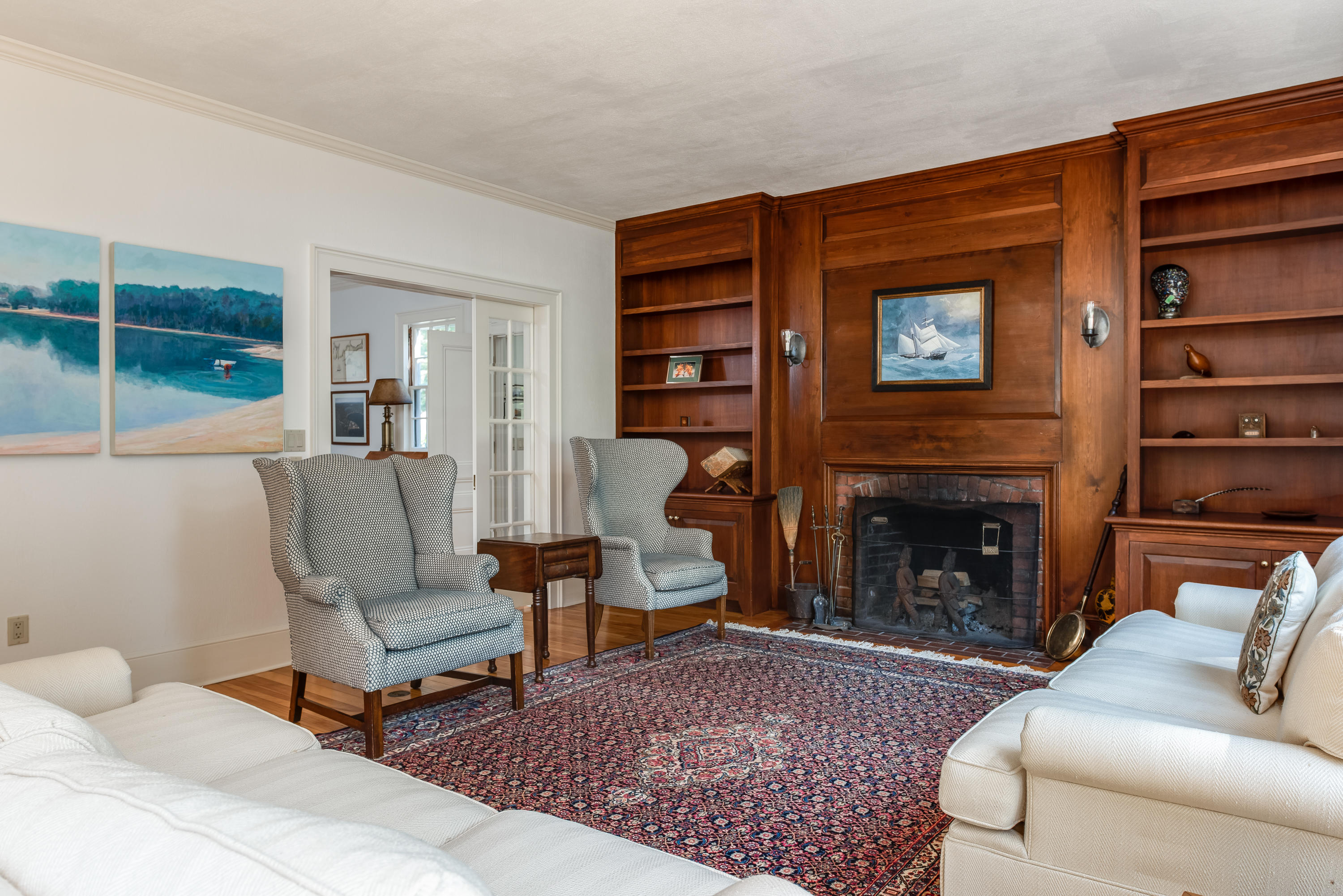 1075 Old Post Road Cotuit, MA 02635 - Photo 13 of 40 a living room with furniture and a fireplace