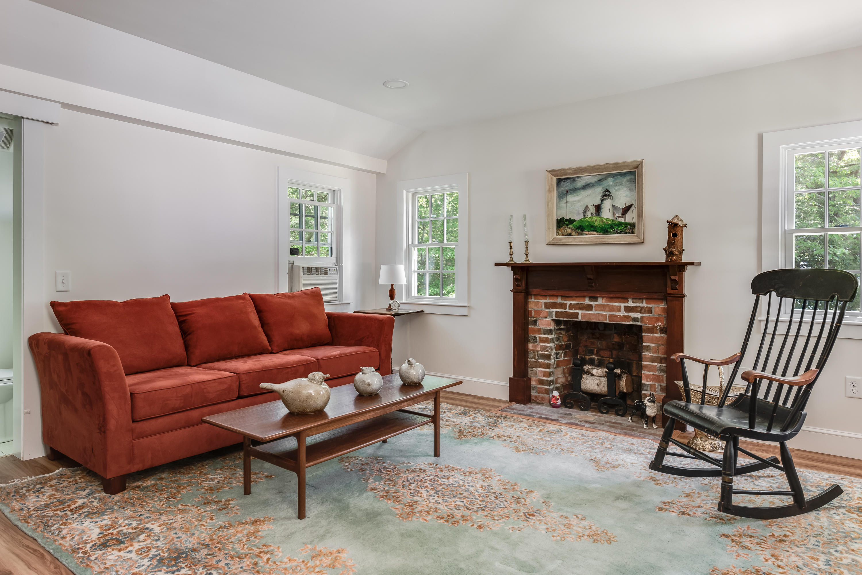 1075 Old Post Road Cotuit, MA 02635 - Photo 22 of 40 a living room with furniture and a fireplace