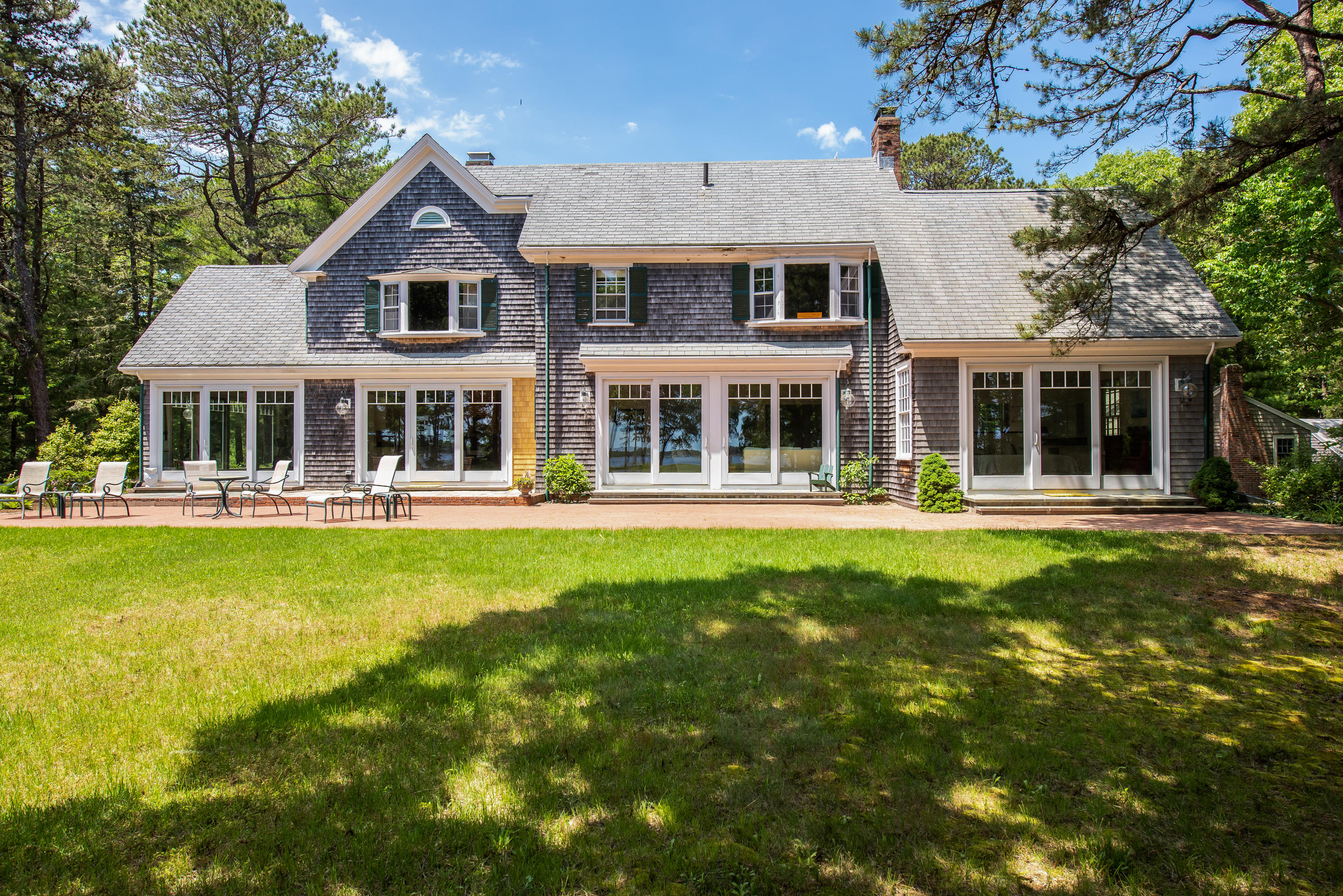 1075 Old Post Road Cotuit, MA 02635 - Photo 23 of 40 a front view of a house with a yard table and chairs