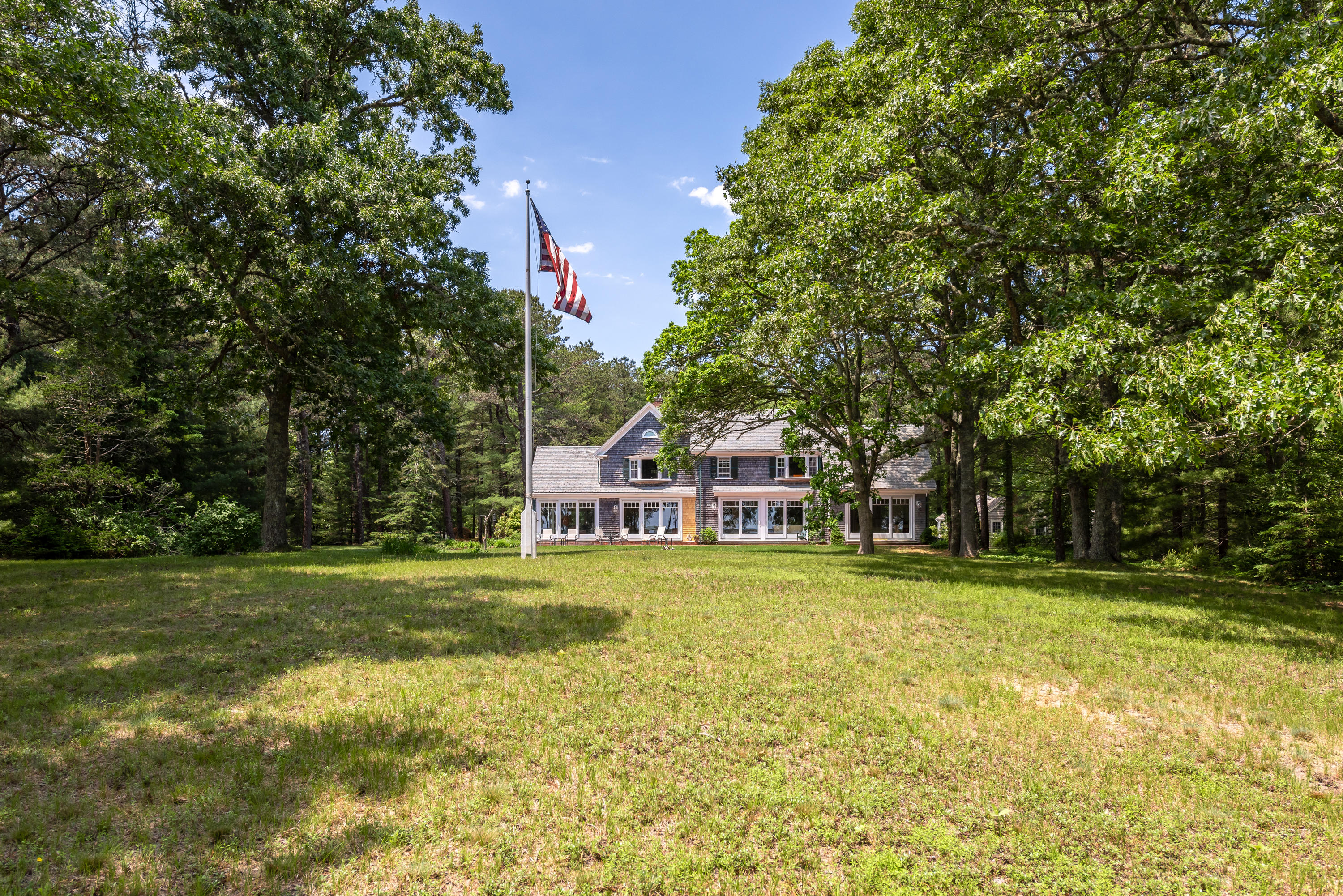 1075 Old Post Road Cotuit, MA 02635 - Photo 26 of 40 a front view of a house with a yard