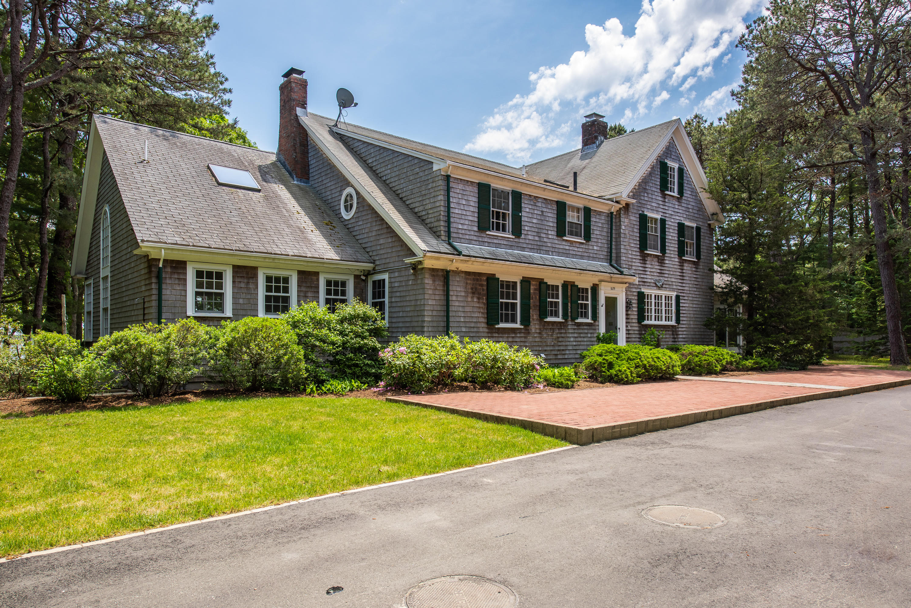 1075 Old Post Road Cotuit, MA 02635 - Photo 3 of 40 a front view of house with yard and green space