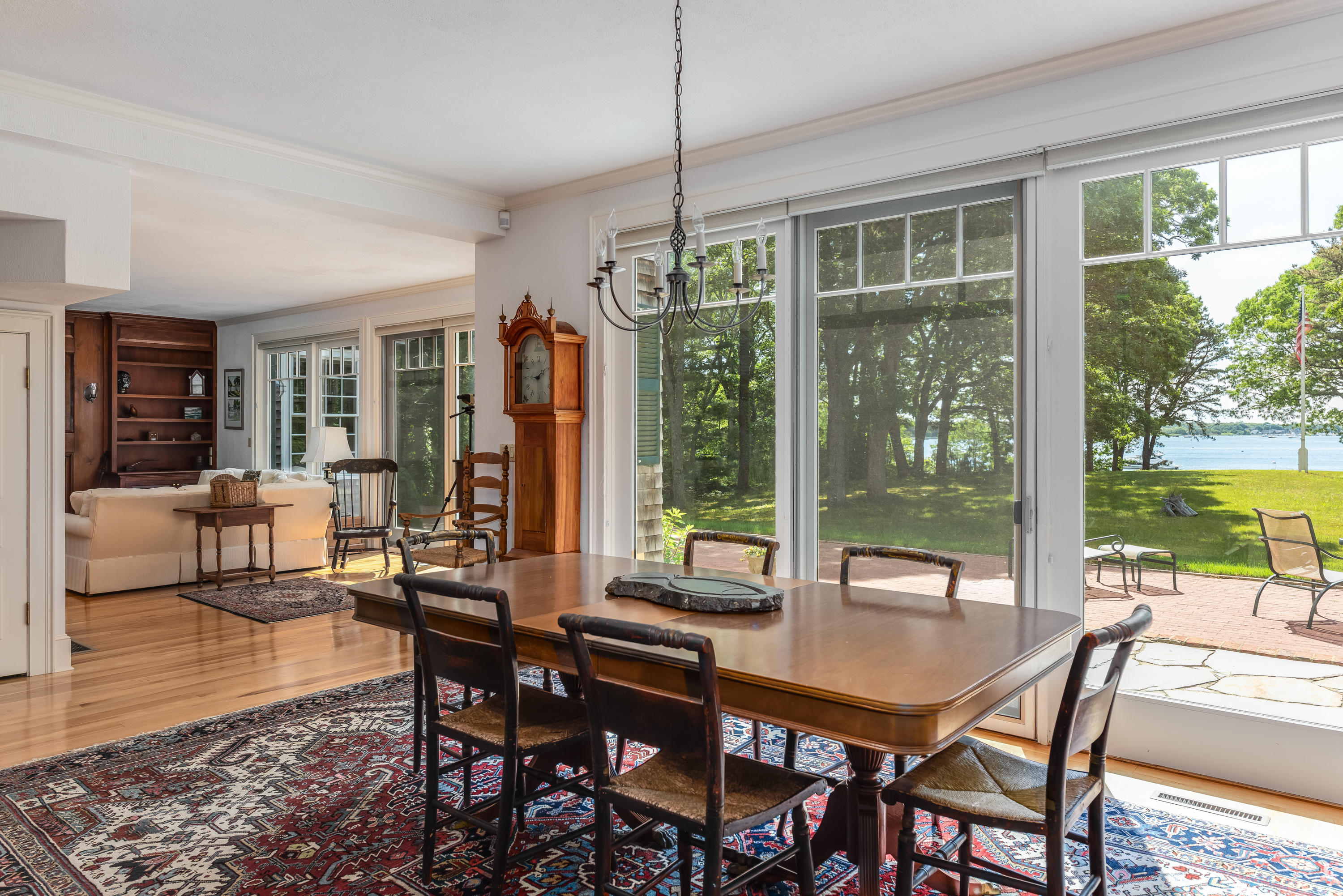 1075 Old Post Road Cotuit, MA 02635 - Photo 6 of 40 a dining room with furniture a chandelier and wooden floor