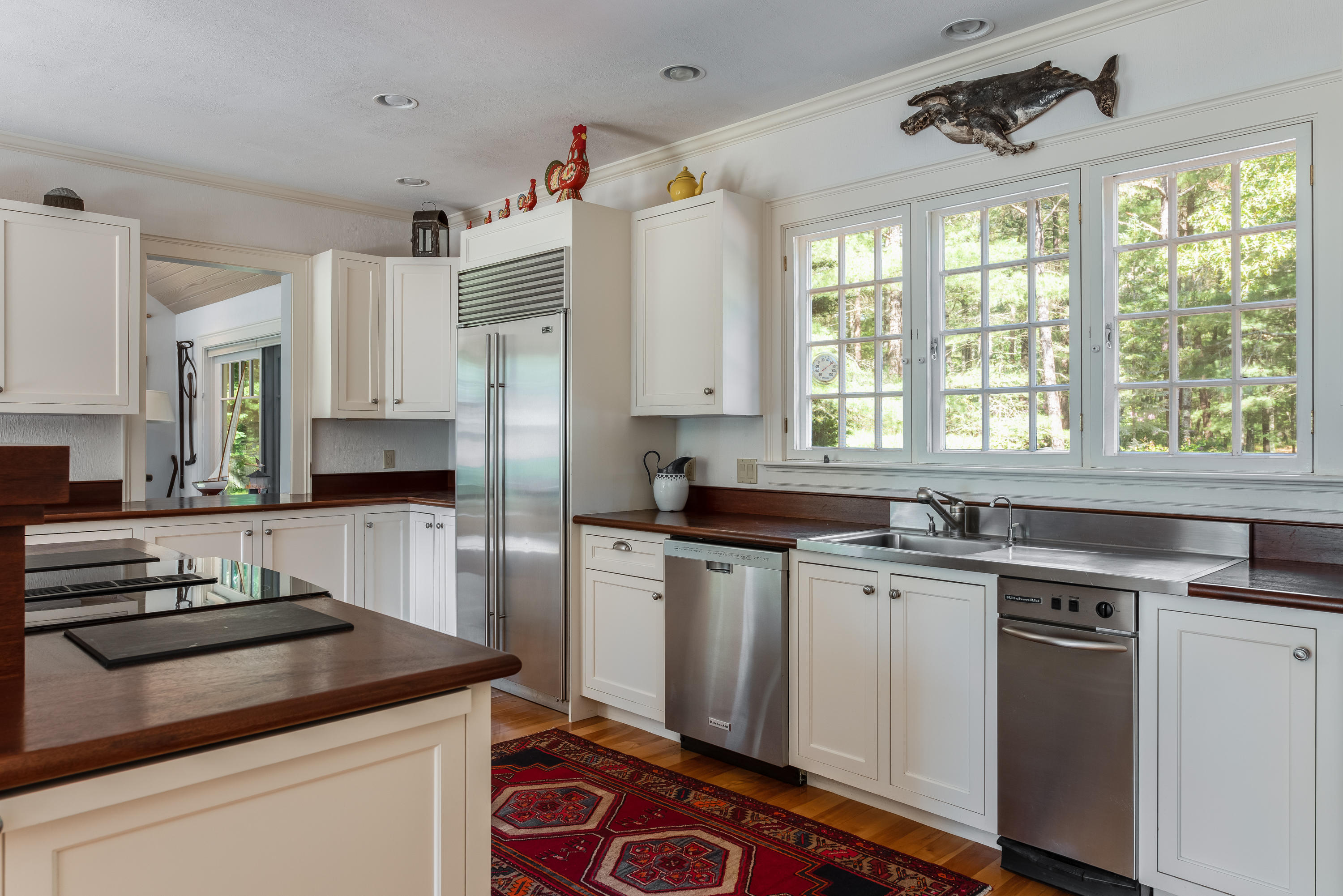 1075 Old Post Road Cotuit, MA 02635 - Photo 8 of 40 a kitchen with appliances cabinets and a sink