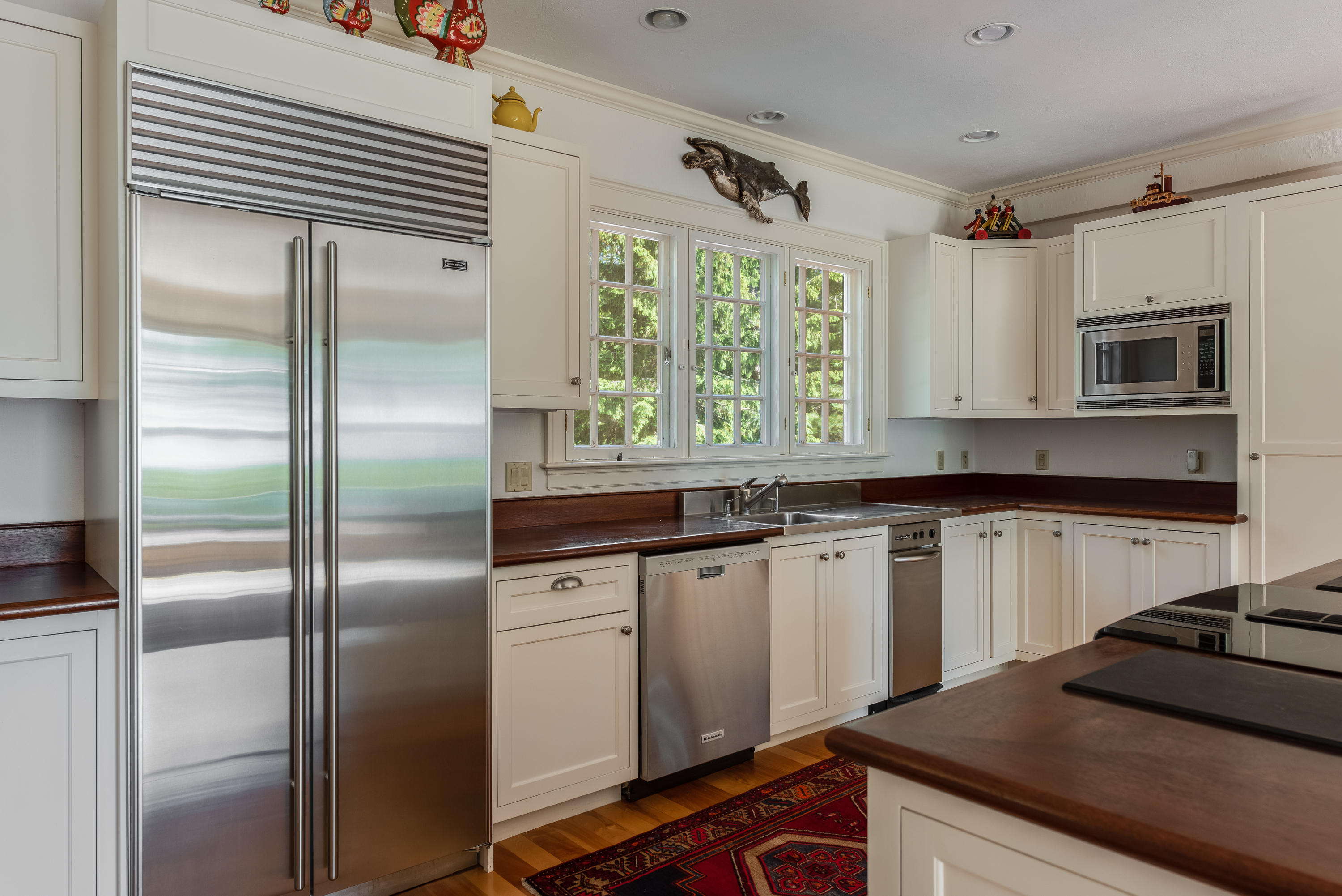 1075 Old Post Road Cotuit, MA 02635 - Photo 9 of 40 a kitchen with stainless steel appliances granite countertop a refrigerator a sink dishwasher a stove and a microwave oven