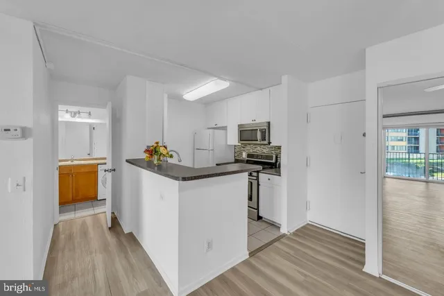 a kitchen with stainless steel appliances a refrigerator and a stove top oven