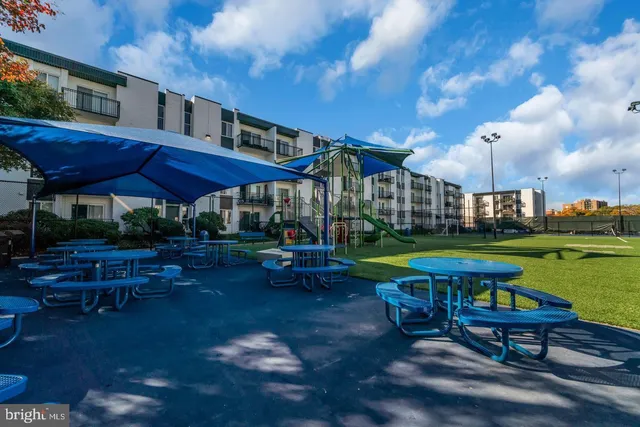 a view of a table and chairs under an umbrella in the patio