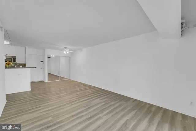 a view of empty room with wooden floor