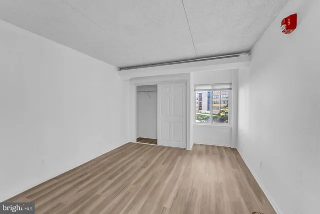 a view of a room with wooden floor and natural light