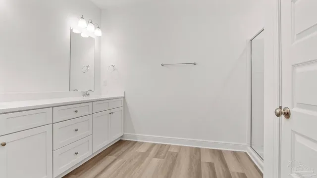 a bathroom with a double vanity sink and mirror