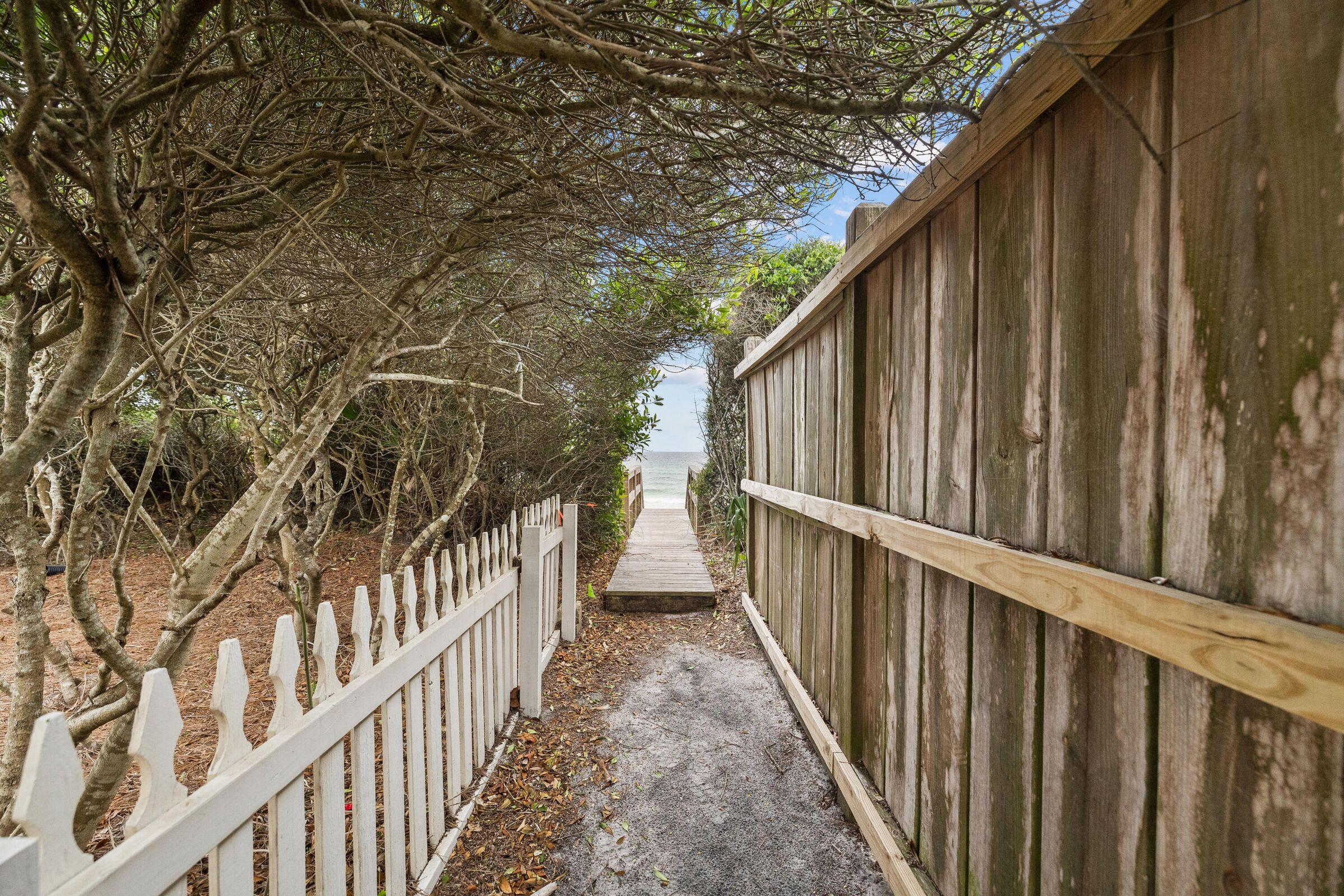 30 Sand Oaks Circle Santa Rosa Beach, FL 32459 - Photo 10 of 14 a view of a pathway of a house with wooden fence and wooden fence