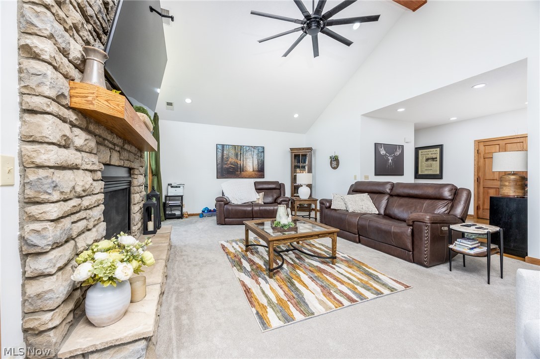 1602 Glendale Road, Unit 3 Marietta, OH 45750 - Photo 6 of 49 Living area featuring a stone-clad fireplace with a wood mantel, vaulted ceiling, recessed lighting, and a contemporary ceiling fan