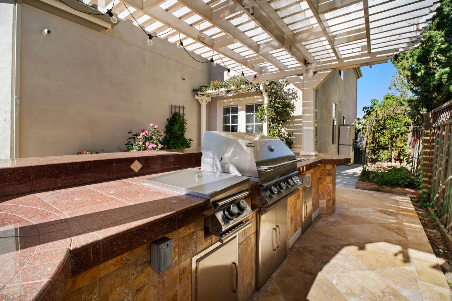 44450 Cavisson Court Fremont, CA 94539 - Photo 13 of 46 a view of a patio with table and chairs with wooden floor and fence