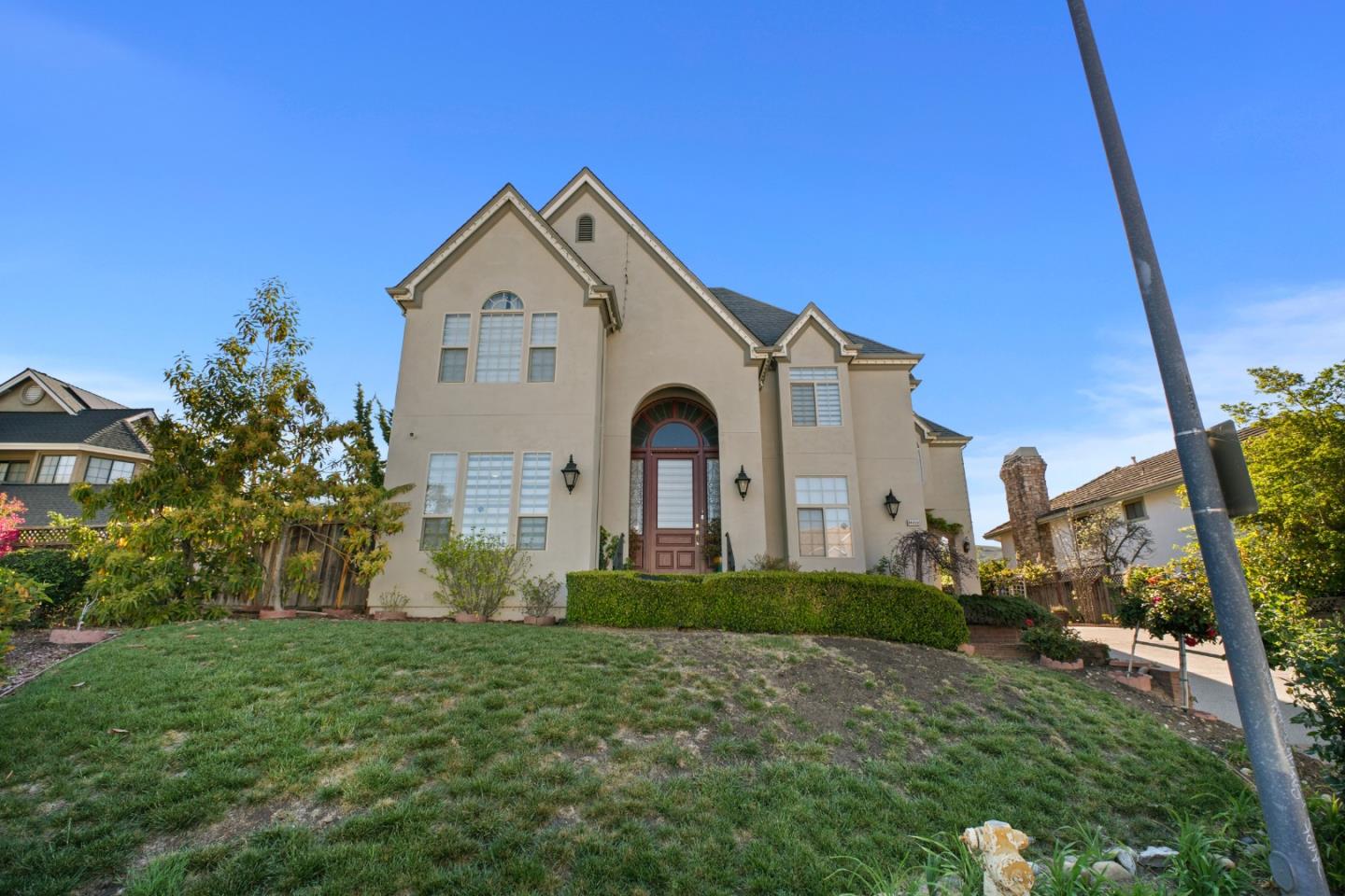 44450 Cavisson Court Fremont, CA 94539 - Photo 3 of 46 a front view of a house with a yard