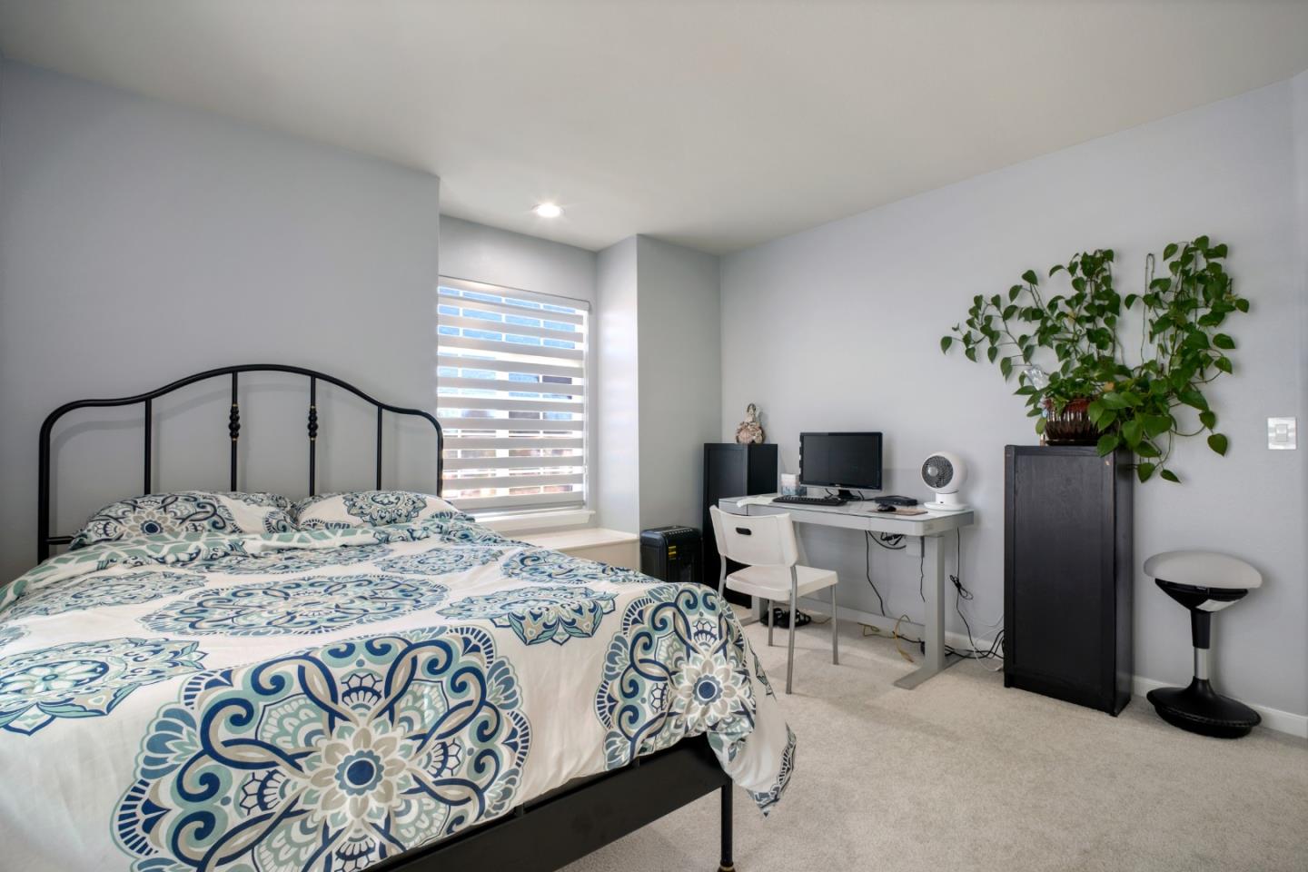 44450 Cavisson Court Fremont, CA 94539 - Photo 34 of 46 a bedroom with a bed and a potted plant