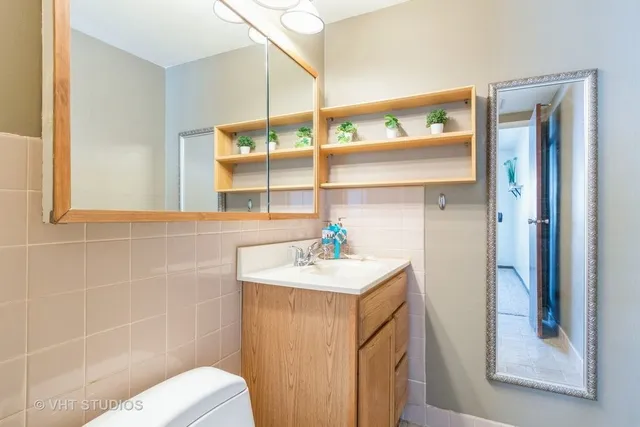 a bathroom with a sink mirror and a shower