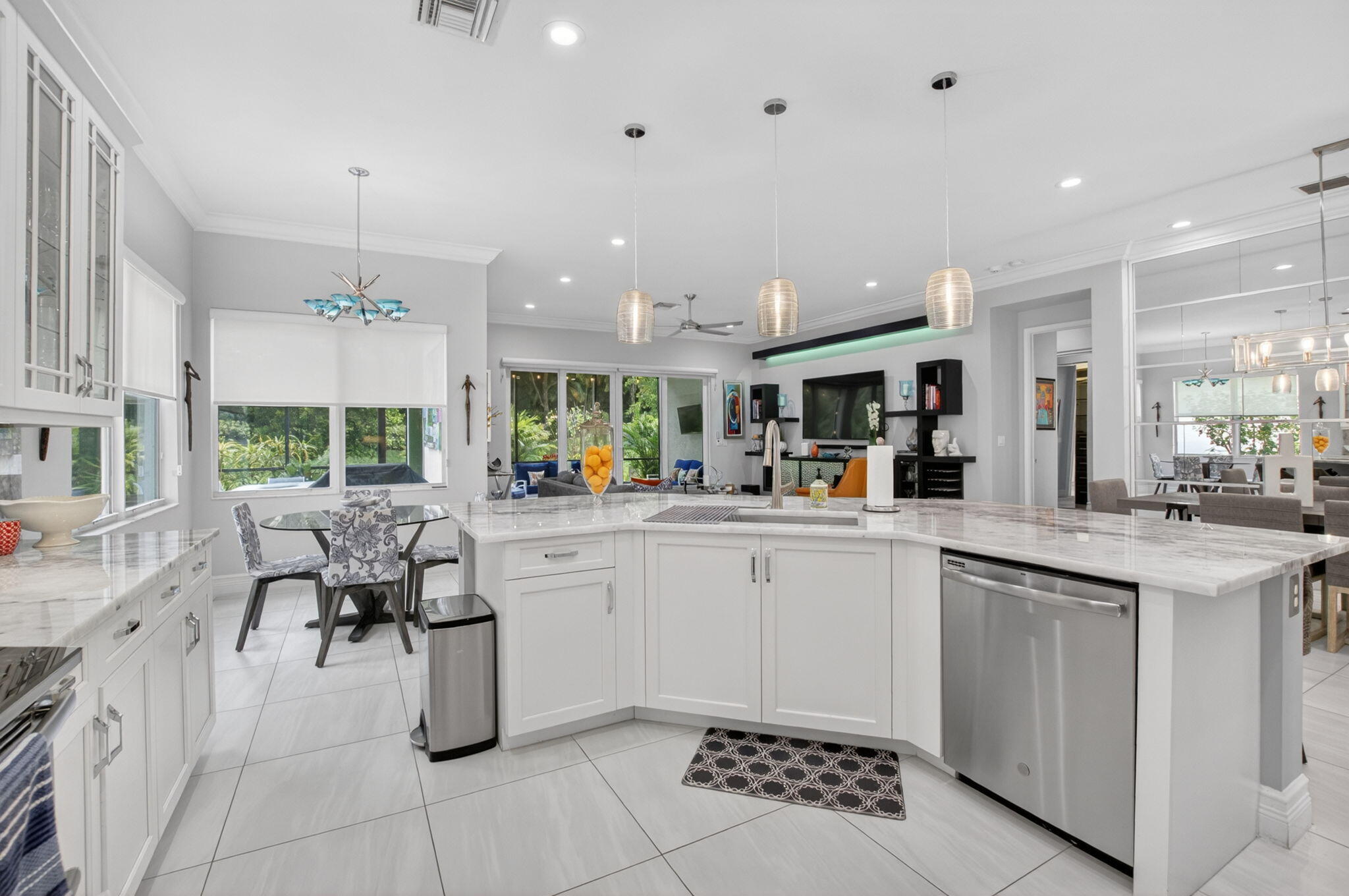 8263 Arabian Range Road Boynton Beach, FL 33473 - Photo 19 of 52 a kitchen with a sink dining table and chairs