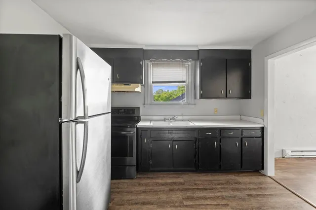 a kitchen with a sink and a refrigerator