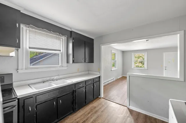 a view with cabinets a sink and a window in a room