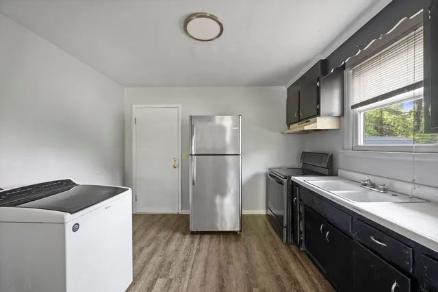 a kitchen with a refrigerator sink and stove