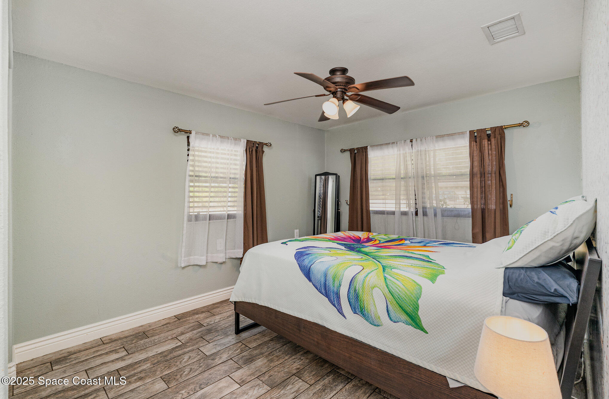 1304 Lichty Street Palm Bay, FL 32905 - Photo 13 of 63 a bedroom with a bed and windows