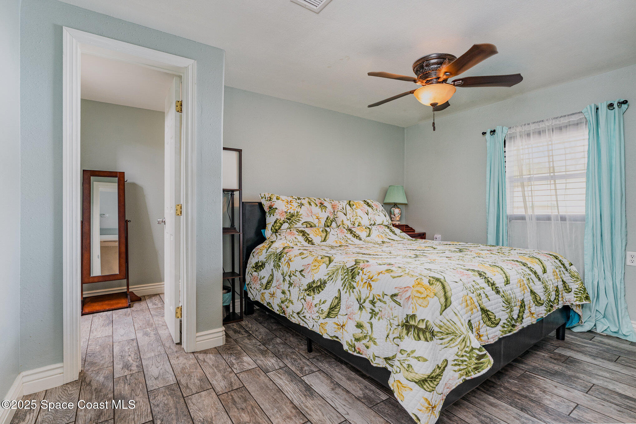 1304 Lichty Street Palm Bay, FL 32905 - Photo 16 of 63 a bedroom with a bed and a chandelier