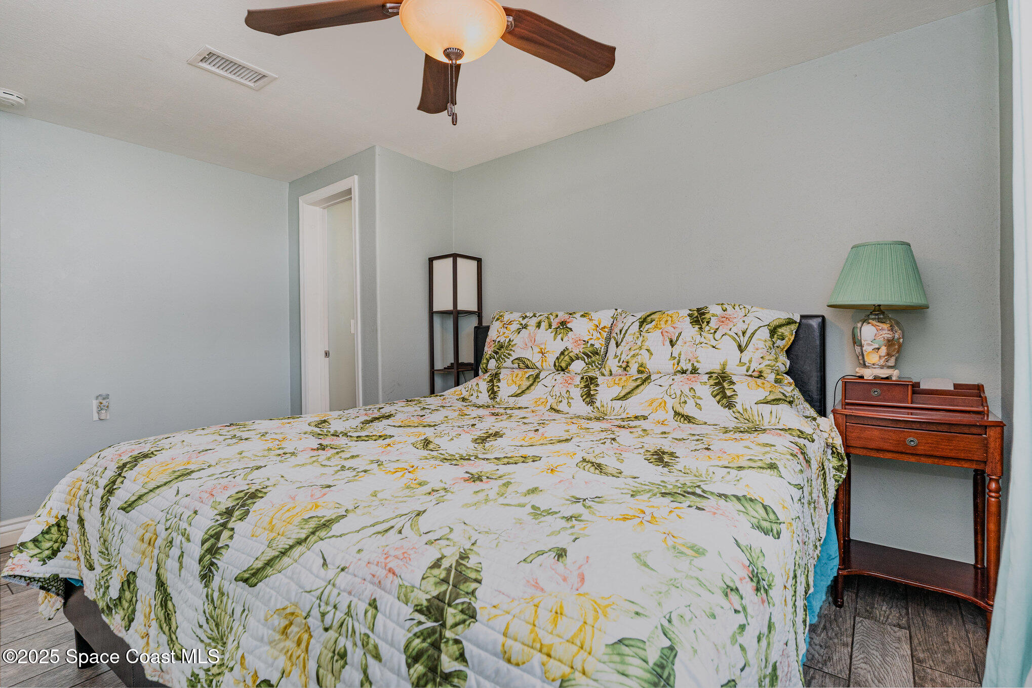 1304 Lichty Street Palm Bay, FL 32905 - Photo 17 of 63 a bedroom with a bed and a lamp