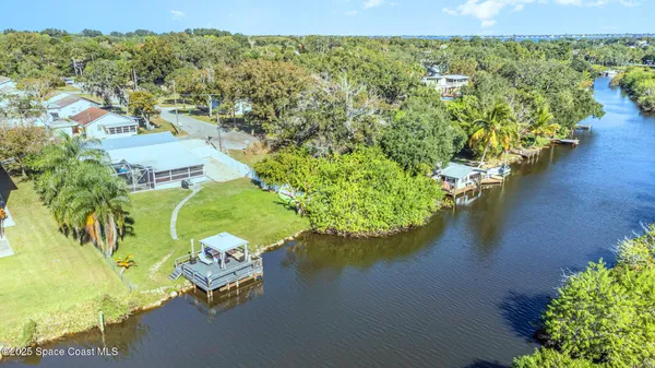 an aerial view of a house with a lake view