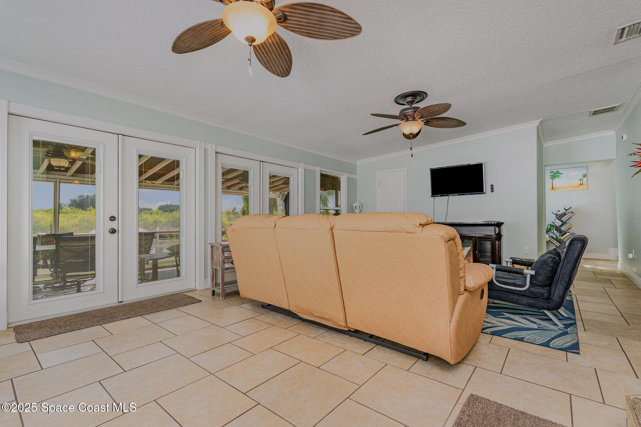 1304 Lichty Street Palm Bay, FL 32905 - Photo 22 of 63 a large bedroom with a large bed and a chandelier