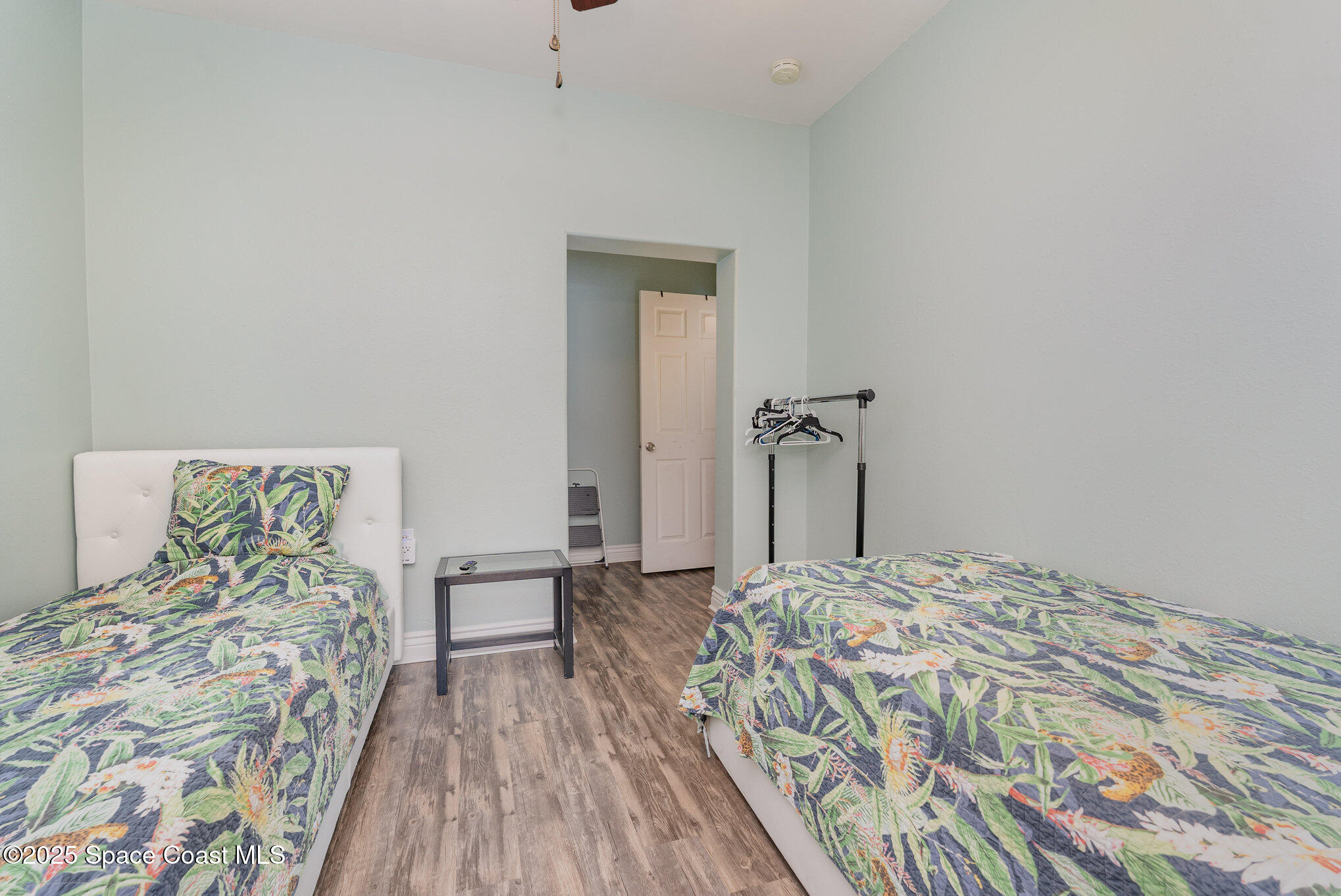 1304 Lichty Street Palm Bay, FL 32905 - Photo 24 of 63 a bedroom with a bed and a chandelier