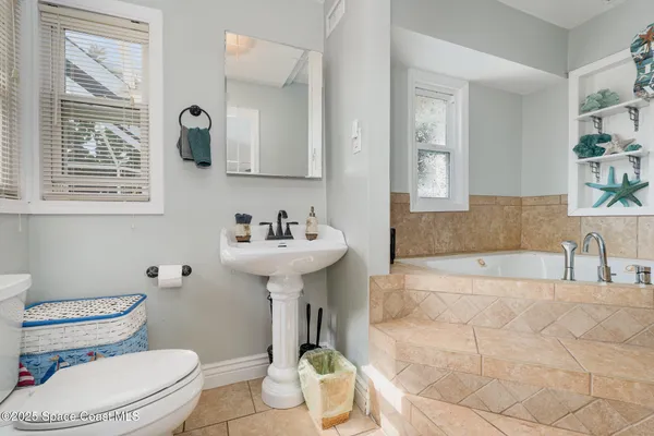 a living room with furniture a rug and a chandelier