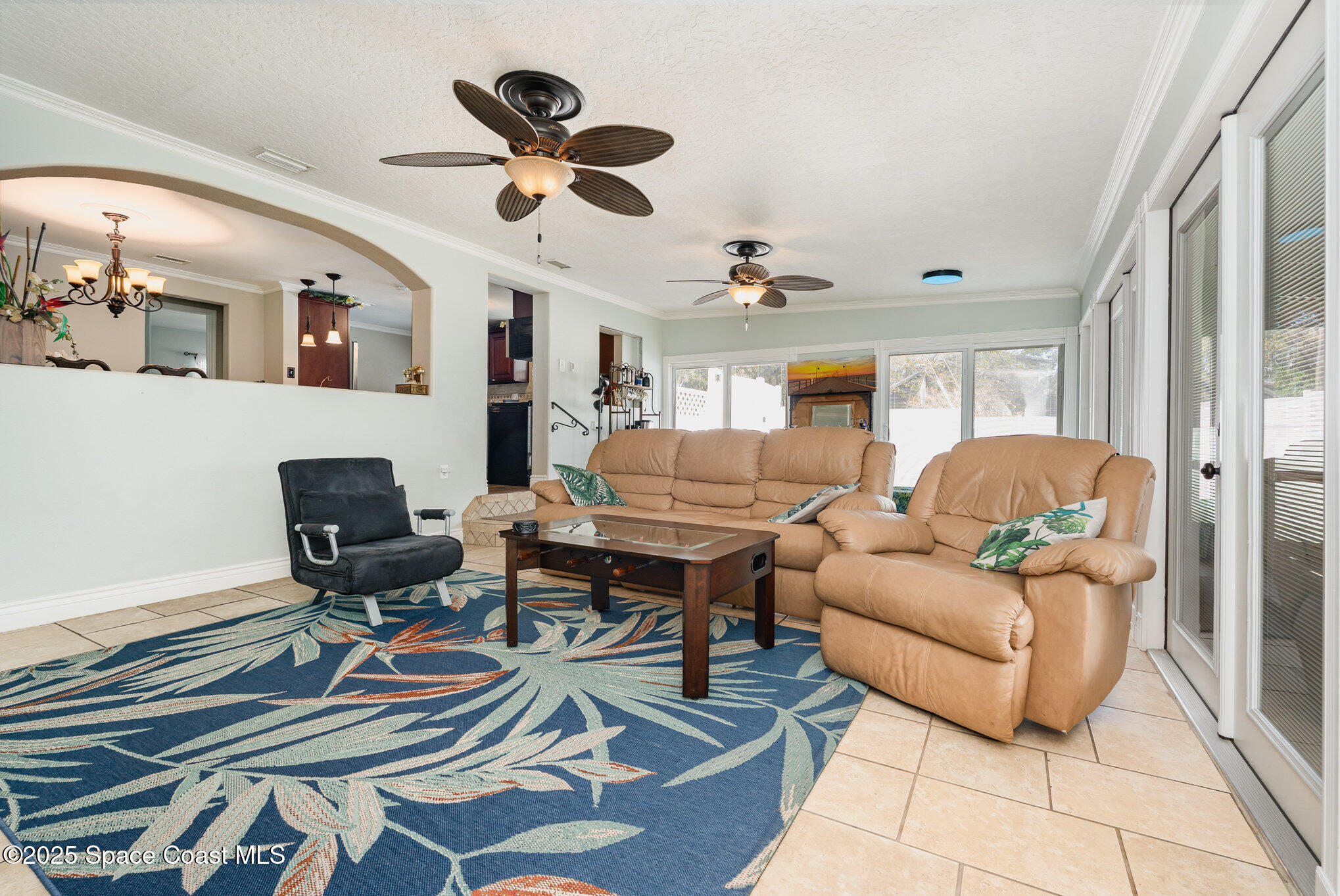 1304 Lichty Street Palm Bay, FL 32905 - Photo 27 of 63 a living room with furniture a rug and a chandelier