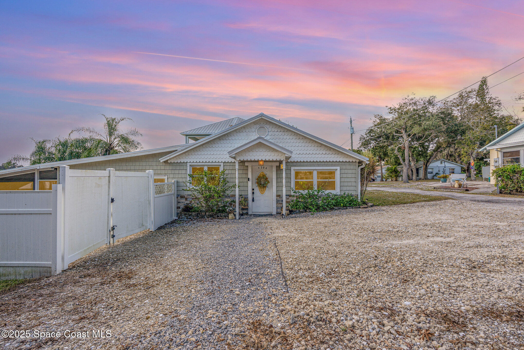 1304 Lichty Street Palm Bay, FL 32905 - Photo 3 of 63 a view of a house with a yard and garage