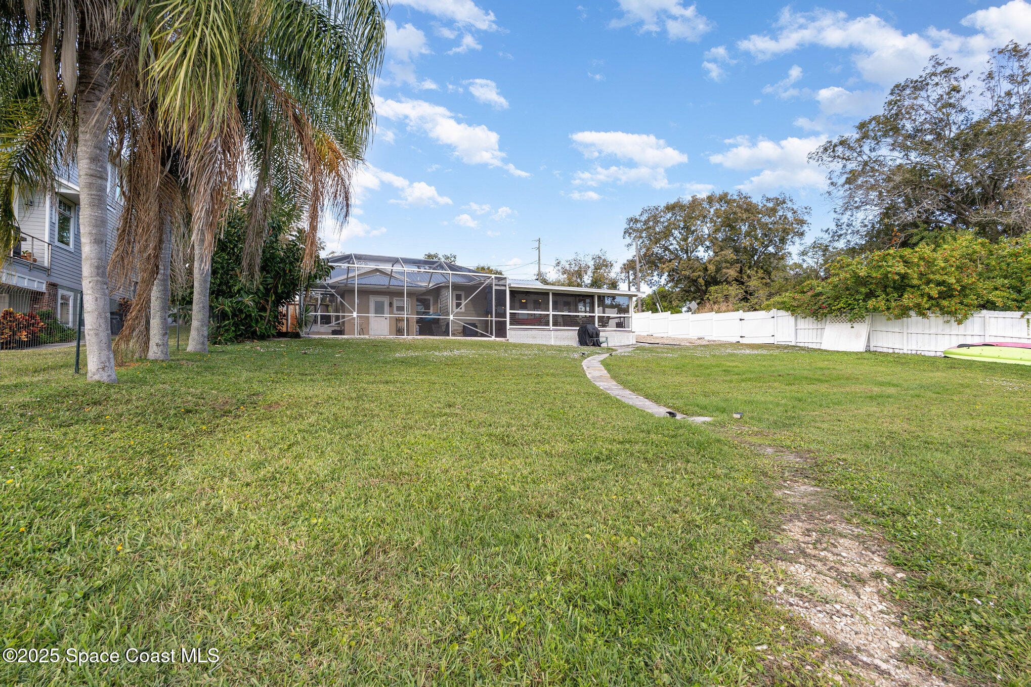 1304 Lichty Street Palm Bay, FL 32905 - Photo 38 of 63 a view of a swimming pool with a yard and palm trees